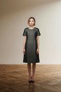 Full body view of the model wearing Luisa Cerano Jurk Maat 40/42 – Grijze Wolmix Jurk met Zwarte Leather-Look Panels | Nieuw met Kaartje