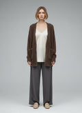 Full body view of the model wearing ESSENTIEL ANTWERP Vest maat S Bruin met goudkleurige glitters